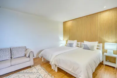 a bedroom with a large bed with yellow pillows at Quinta da Vila in Porto da Cruz