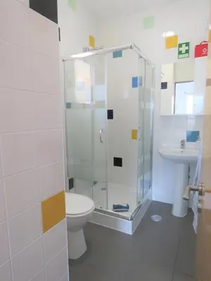 a bathroom with a shower and a toilet and a sink at Sagres Relax Studios in Sagres