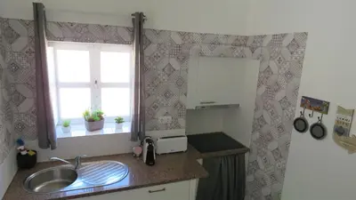 a small kitchen with a sink and a window at Sagres Relax Studios in Sagres