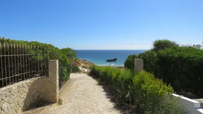 a path leading down to a beach with the ocean at Sagres Relax Studios in Sagres