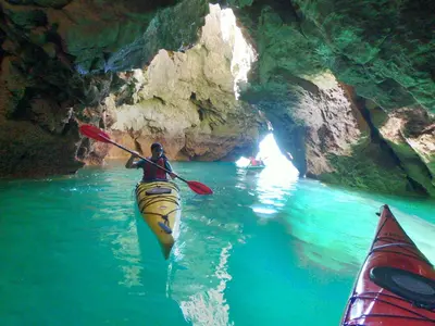 a man in a kayak in a cave at Sagres Relax Studios in Sagres