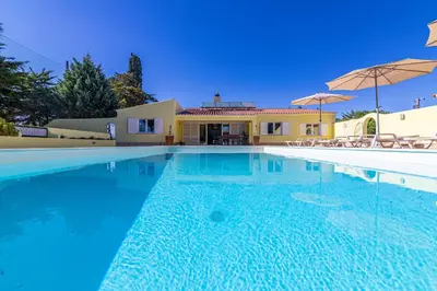 a large swimming pool in front of a house at Casa Dean by Algarve Golden Properties in Lagos