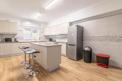 a kitchen with a refrigerator and two bar stools at Casa Dean by Algarve Golden Properties in Lagos
