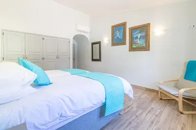 a bedroom with a large bed and a chair at Casa Dean by Algarve Golden Properties in Lagos