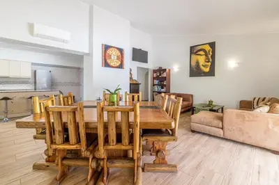 a living room with a wooden table and chairs at Casa Dean by Algarve Golden Properties in Lagos
