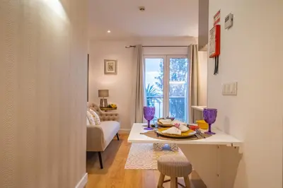 a kitchen and living room with a table and chairs at Funchal Center Apartment I in Funchal