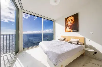 a bedroom with a bed and a large window at Barreirinha Front-Line Sea View I by Holiday Rental Madeira in Funchal