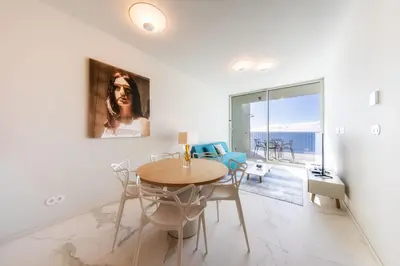 a dining room with a table and chairs at Barreirinha Front-Line Sea View I by Holiday Rental Madeira in Funchal