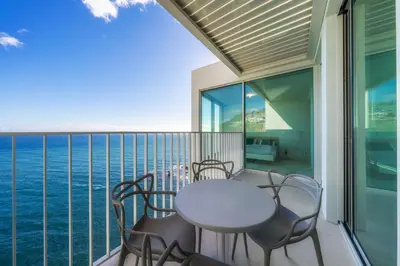 a balcony with a table and chairs and the ocean at Barreirinha Front-Line Sea View II by Holiday Rental Madeira in Funchal