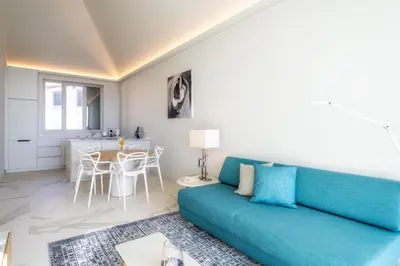 a living room with a blue couch and a table at Barreirinha Front-Line Sea View II by Holiday Rental Madeira in Funchal