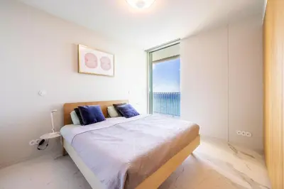 a bedroom with a bed and a large window at Barreirinha Front-Line Sea View II by Holiday Rental Madeira in Funchal