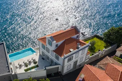 an aerial view of a house and the ocean at Barreirinha Suite Top Floor by Holiday Rental Madeira in Funchal
