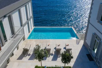 a swimming pool on the balcony of a building with the ocean at Barreirinha Suite Top Floor by Holiday Rental Madeira in Funchal
