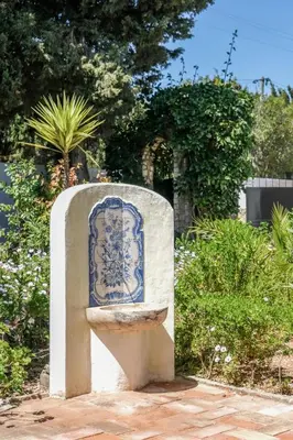 a statue of a fountain in a garden at Casa Monte Cristo Tres in Lagos