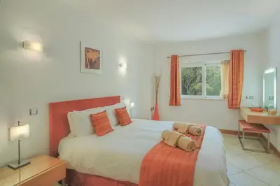 a bedroom with a bed and a desk and a window at Casa Monte Cristo Apartments - Orange in Lagos