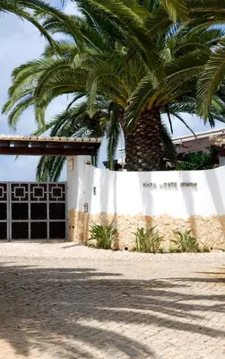 a house with a palm tree in front of a garage at Casa Monte Cristo Apartments - Orange in Lagos
