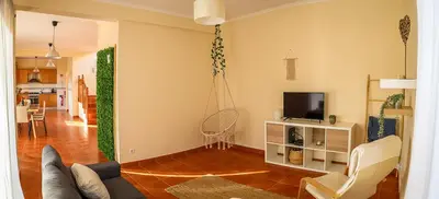 a living room with a couch and a tv at O DRAGOEIRO da Madalena! in Porto Santo