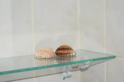 three knitted muffins sitting on a glass shelf at O DRAGOEIRO da Madalena! in Porto Santo
