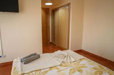 a large bed in a room with a window at O DRAGOEIRO da Madalena! in Porto Santo