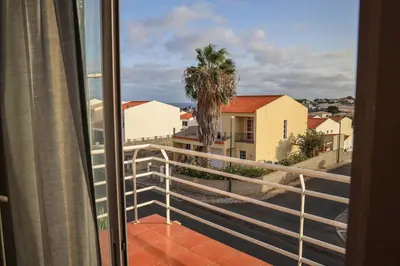 a balcony with a view of a palm tree at O DRAGOEIRO da Madalena! in Porto Santo