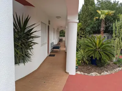 a hallway of a house with plants and a column at Casa Monte Cristo Apartments - Lemon in Lagos