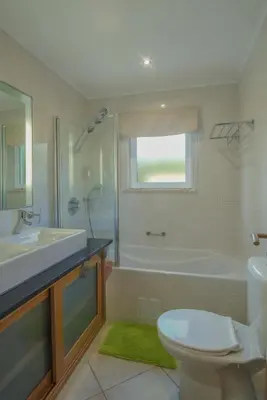 a bathroom with a tub and a sink and a toilet at Casa Monte Cristo Apartments - Lemon in Lagos