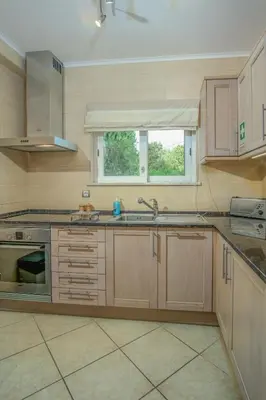 a large kitchen with a sink and a window at Casa Monte Cristo Apartments - Lemon in Lagos