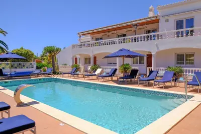 a swimming pool in front of a villa at Casa Monte Cristo Apartments - Lemon in Lagos