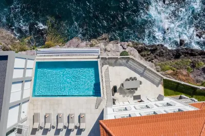 a swimming pool on top of a building with the ocean at Barreirinha Suite by Holiday Rental Madeira in Funchal
