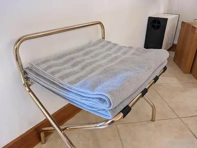 a bed with a blue blanket on top of it at Casa Monte Cristo Apartments - Plum in Lagos