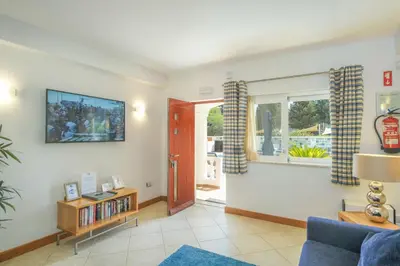 a living room with a blue couch and a window at Casa Monte Cristo Apartments - Plum in Lagos