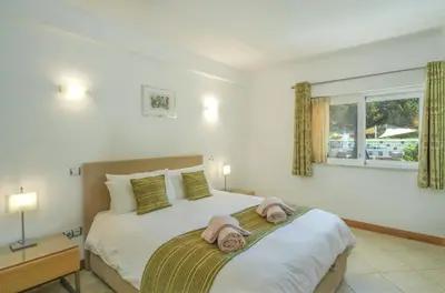 a bedroom with a large bed with towels on it at Casa Monte Cristo Apartments - Lime in Lagos
