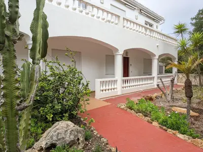 a courtyard of a house with a red walkway at Casa Monte Cristo Apartments - Lime in Lagos