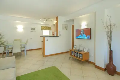 a living room with a couch and a tv on the wall at Casa Monte Cristo Apartments - Lime in Lagos