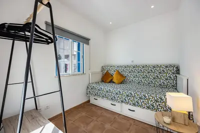 a room with a bed and a ladder at Salema Beach House in Salema