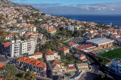 an aerial view of a city with the ocean at ALEGRIA II in Funchal