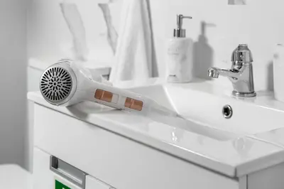 a hair dryer sitting on a bathroom sink at ALEGRIA II in Funchal