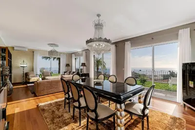 a dining room with a table and chairs at Exquisite Madeira Villa Villa Funchal Belair 4 Bedroom Panoramic Sea View in Funchal