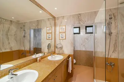 a bathroom with two sinks and a shower at Exquisite Madeira Villa Villa Funchal Luz 5 Bedroom Heated Pool in Funchal