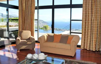 a living room with a couch and two chairs at Exquisite Madeira Villa Villa Funchal Luz 5 Bedroom Heated Pool in Funchal