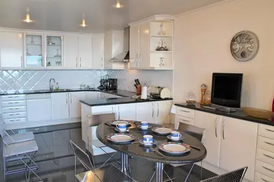 a kitchen with a table and chairs in a kitchen at Exquisite Madeira Villa Villa Funchal Luz 5 Bedroom Heated Pool in Funchal