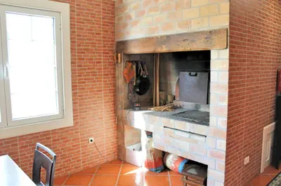 a kitchen with a brick wall with a stove at Magnificent Funchal Villa Villa Luzia 5 Bedrooms Sea & City Views in Funchal