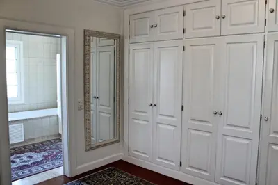 a bathroom with white cabinets and a mirror at Magnificent Funchal Villa Villa Luzia 5 Bedrooms Sea & City Views in Funchal