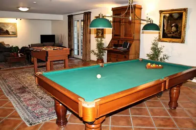 a living room with a pool table in it at Magnificent Funchal Villa Villa Luzia 5 Bedrooms Sea & City Views in Funchal