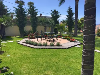 a park with a picnic table and flowers at Magnificent Funchal Villa Villa Luzia 5 Bedrooms Sea & City Views in Funchal