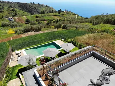 an overhead view of a swimming pool with umbrellas at Beautiful Calheta Villa Villa Bella Vita 3 Bedrooms Stunning Sea Views in Calheta