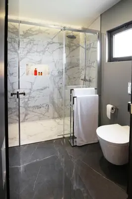 a bathroom with a shower and a toilet and a sink at Beautiful Calheta Villa Villa Bella Vita 3 Bedrooms Stunning Sea Views in Calheta