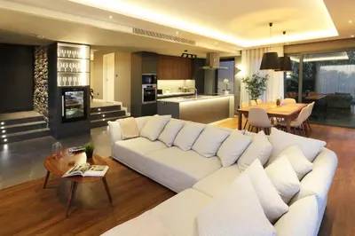 a living room with a white couch and a kitchen at Beautiful Calheta Villa Villa Bella Vita 3 Bedrooms Stunning Sea Views in Calheta