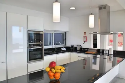 a kitchen with a counter with a bowl of fruit on it at Spectacular Calheta Villa Villa Cliffscape 3 Bedrooms Panoramic Sea View in Estreito da Calheta
