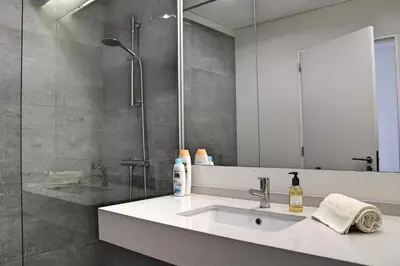 a bathroom with a sink and a shower at Spectacular Calheta Villa Villa Cliffscape 3 Bedrooms Panoramic Sea View in Estreito da Calheta